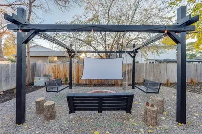 a swing set with a white screen in a backyard at Games Gone Wild Between Red Rocks And Downtown Denver In Arvada in Arvada