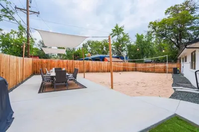 a volleyball court with chairs and a net at Groovy Getaway With 4 KING Beds And A Hot Tub in Westminster