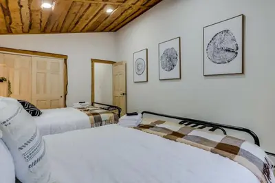 two beds in a room with two at Mountain Mansion With A Hot Tub And A Sauna in Morrison