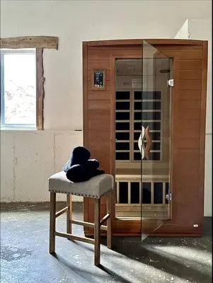 a chair sitting in front of a glass cabinet at Mountain Mansion With A Hot Tub And A Sauna in Morrison