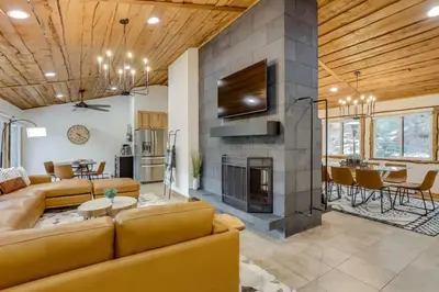 a living room with a couch and a fireplace at Mountain Mansion With A Hot Tub And A Sauna in Morrison