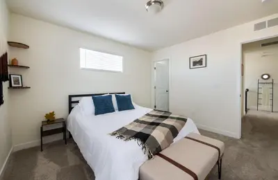 a bedroom with a large white bed with blue pillows at The Stylish Stay Is A Brand New Construction in Thornton