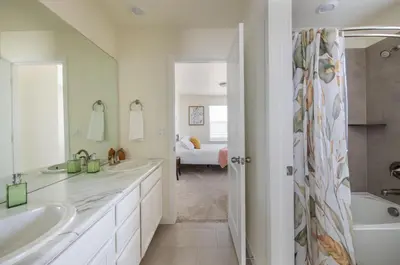 a white bathroom with two sinks and a tub at The Stylish Stay Is A Brand New Construction in Thornton