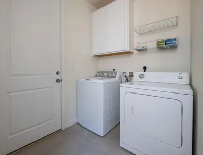 a white laundry room with a washer and dryer at The Stylish Stay Is A Brand New Construction in Thornton