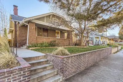 a brick house with a brick retaining wall at Highlands Bungalow With A Back Yard And A Fire Pit in Denver