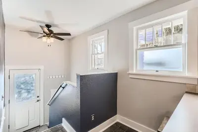 a kitchen with a refrigerator and a ceiling fan at Highlands Bungalow With A Back Yard And A Fire Pit in Denver
