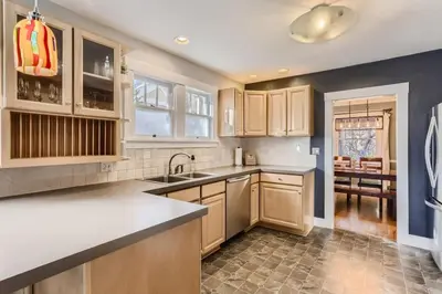 a kitchen with wooden cabinets and a sink at Highlands Bungalow With A Back Yard And A Fire Pit in Denver