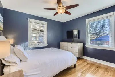 a bedroom with a bed and a ceiling fan at Highlands Bungalow With A Back Yard And A Fire Pit in Denver
