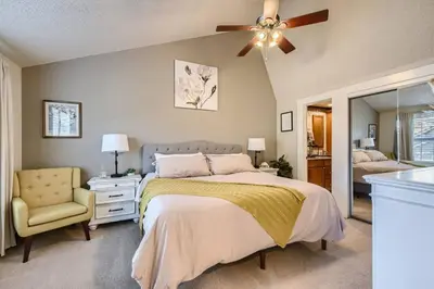 a bedroom with a bed and a ceiling fan at Pet Friendly Townhome WIth A Fireplace And A King Bed In Littleton in Littleton