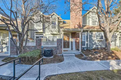 a brick house with a chimney at Pet Friendly Townhome WIth A Fireplace And A King Bed In Littleton in Littleton