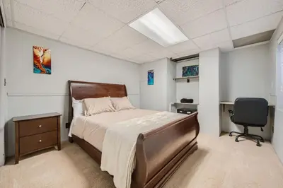 a bedroom with a bed and a desk and a chair at Pet Friendly Townhome WIth A Fireplace And A King Bed In Littleton in Littleton