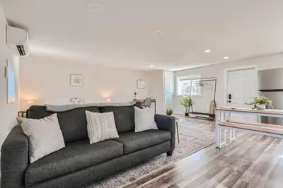 a living room with a couch and a table at Pet Friendly Carriage House Near Red Rocks And Regis in Denver