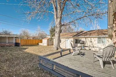 a deck with two chairs and a tree at Pet Friendly Carriage House Near Red Rocks And Regis in Denver