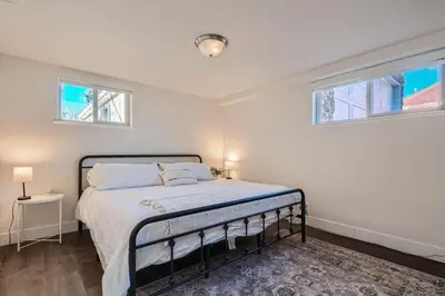a bedroom with a bed and two windows at Sleeps 10 And Pet Friendly Home In Denver Near Red Rocks in Denver