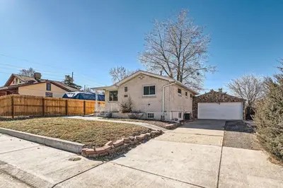 a house with a fence and a driveway at 4 Bedroom Bungalow Pet Friendly Near Regis And Red Rocks And Tennyson in Denver