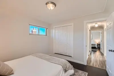 a white bedroom with a bed and a window at 4 Bedroom Bungalow Pet Friendly Near Regis And Red Rocks And Tennyson in Denver