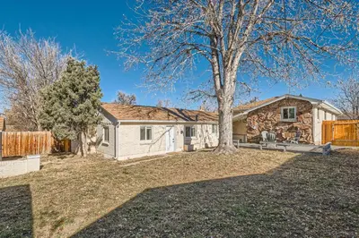 a house with a tree in the yard at 4 Bedroom Bungalow Pet Friendly Near Regis And Red Rocks And Tennyson in Denver