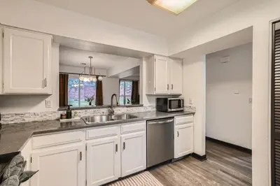 a kitchen with white cabinets and a sink and a microwave at Modern Home In West Denver 15 Min Close To Downtown in Westminster