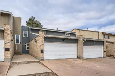 a house with two garage doors in a parking lot at Modern Home In West Denver 15 Min Close To Downtown in Westminster