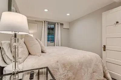 a bedroom with a bed with a lamp and a dresser at Guest Suite At Hilltop And Cherry Creek Near to Museums in Denver