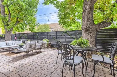 a patio with a table and chairs and a tree at Guest Suite At Hilltop And Cherry Creek Near to Museums in Denver