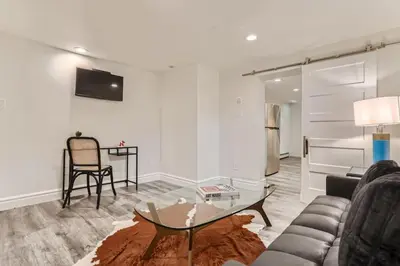a living room with a couch and a table at Guest Suite At Hilltop And Cherry Creek Near to Museums in Denver