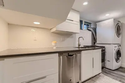 a kitchen with a sink and a washer and dryer at Guest Suite At Hilltop And Cherry Creek Near to Museums in Denver