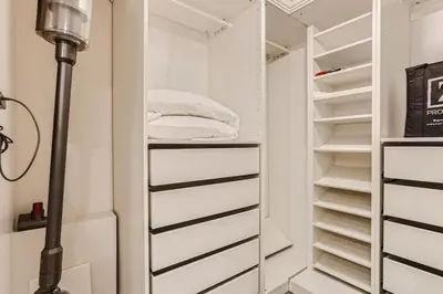 a closet with white shelves and a floor lamp at Guest Suite At Hilltop And Cherry Creek Near to Museums in Denver