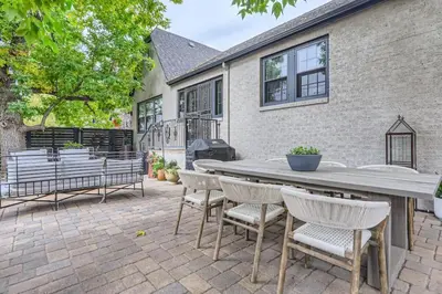 a patio with a wooden table and chairs at Guest Suite At Hilltop And Cherry Creek Near to Museums in Denver