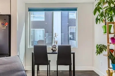 a kitchen with a table and two chairs in front of a window at 3 Bedrooms 2 Bath Townhome In West Denver Near to Red Rocks And Foothills in Lakewood