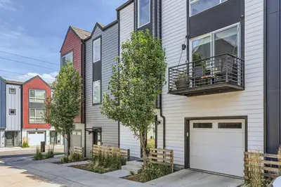 a house with a white garage door and trees at 3 Bedrooms 2 Bath Townhome In West Denver Near to Red Rocks And Foothills in Lakewood
