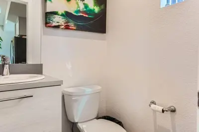 a bathroom with a white toilet and a sink at 3 Bedrooms 2 Bath Townhome In West Denver Near to Red Rocks And Foothills in Lakewood
