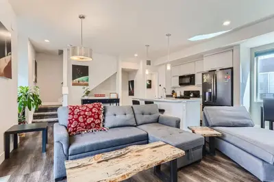 a living room with a couch and a kitchen at 3 Bedrooms 2 Bath Townhome In West Denver Near to Red Rocks And Foothills in Lakewood