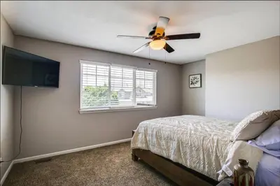 a bedroom with a ceiling fan and a bed at Near to DIA Airport retreat And 20 Min To Downtown Denver in Henderson