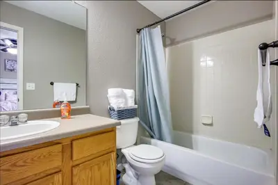 a bathroom with a toilet and a sink and a shower at Near to DIA Airport retreat And 20 Min To Downtown Denver in Henderson