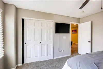 a bedroom with a bed and a flat screen tv at Near to DIA Airport retreat And 20 Min To Downtown Denver in Henderson