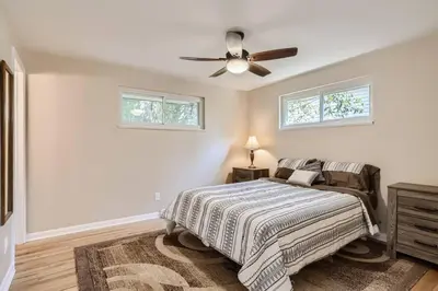 a bedroom with a bed and a ceiling fan at Pet Friendly 3 Bedroom Near to Red Rocks And Belmar In Denver in Lakewood