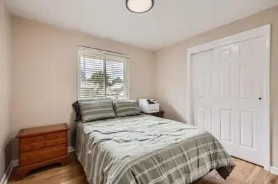 a bedroom with a bed and a white door at Pet Friendly 3 Bedroom Near to Red Rocks And Belmar In Denver in Lakewood