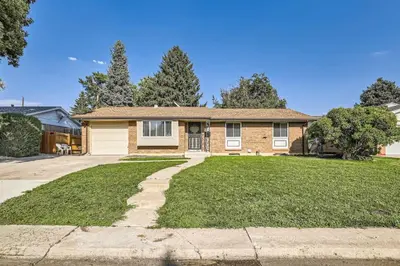 a brick house with a large yard at Pet Friendly 3 Bedroom Near to Red Rocks And Belmar In Denver in Lakewood