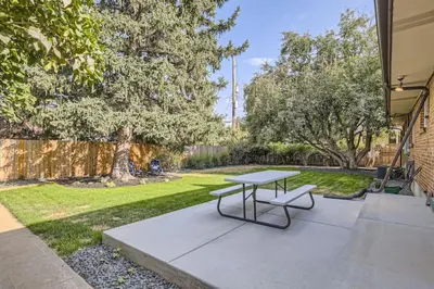 a picnic table in the middle of a yard at Pet Friendly 3 Bedroom Near to Red Rocks And Belmar In Denver in Lakewood