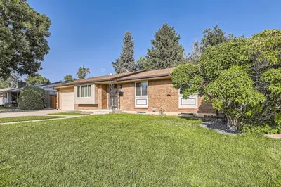 a brick house with a lawn in front of it at Pet Friendly 3 Bedroom Near to Red Rocks And Belmar In Denver in Lakewood