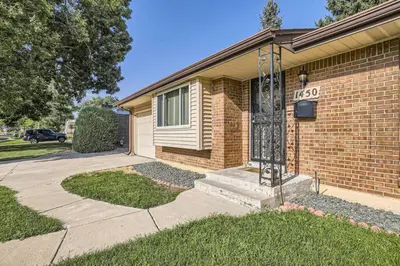 a brick house with a gate and a driveway at Pet Friendly 3 Bedroom Near to Red Rocks And Belmar In Denver in Lakewood