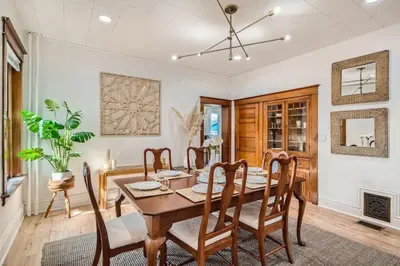 a dining room with a wooden table and chairs at Remodeled 3 Bedroom Close to St Broadway And Sante Fe And CBD in Denver