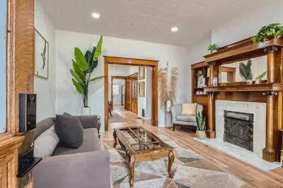 a living room with a couch and a fireplace at Remodeled 3 Bedroom Close to St Broadway And Sante Fe And CBD in Denver