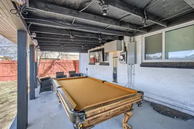 a pool table in the middle of a garage at Basement Guest Suite With A Pool Table A Hot Tub And A TV in Denver