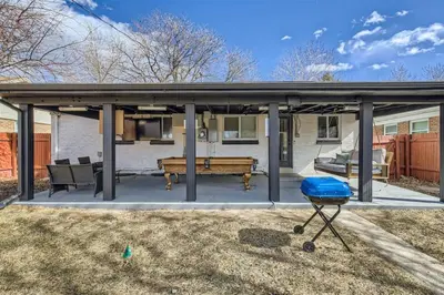 a pavilion with a bench and a grill in a yard at Basement Guest Suite With A Pool Table A Hot Tub And A TV in Denver
