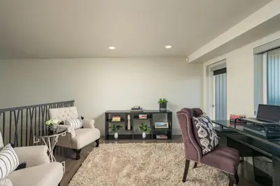 a living room with a desk and a chair at Ultra Luxury Loft With A Fireplace In The Rooftop In RiNo in Denver