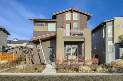 a house with a balcony on the side of it at New Central Park Home Near DIA And 20mins to Downtown in Denver