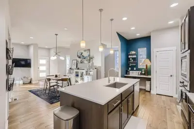 a large kitchen with a sink and a table at New Central Park Home Near DIA And 20mins to Downtown in Denver