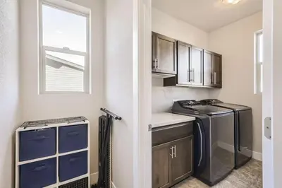 a kitchen with a washer and dryer and a window at New Central Park Home Near DIA And 20mins to Downtown in Denver